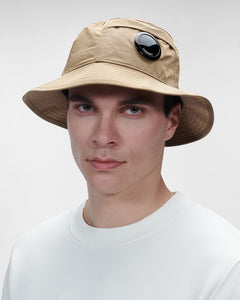 CP Company Chrome-R Lens Bucket Hat In Beige